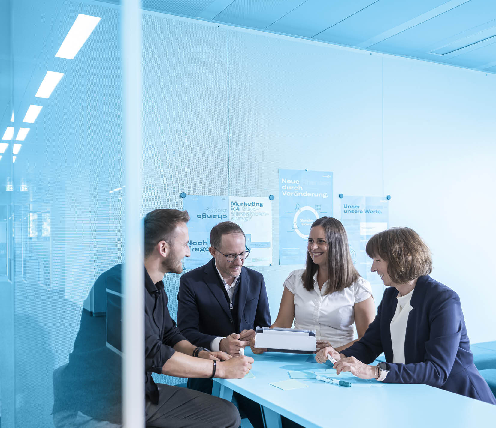  Four people at a creative meeting | Sandler Group 